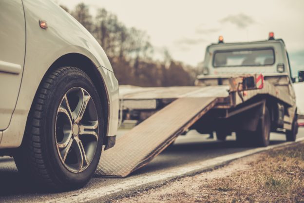 5 Important Things to Remember About Any Car Accident - Loading broken car on a tow truck on a roadside